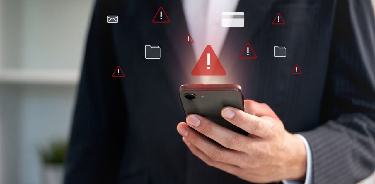 A person in a suit holds a smartphone surrounded by floating alert icons and digital symbols representing risky files.